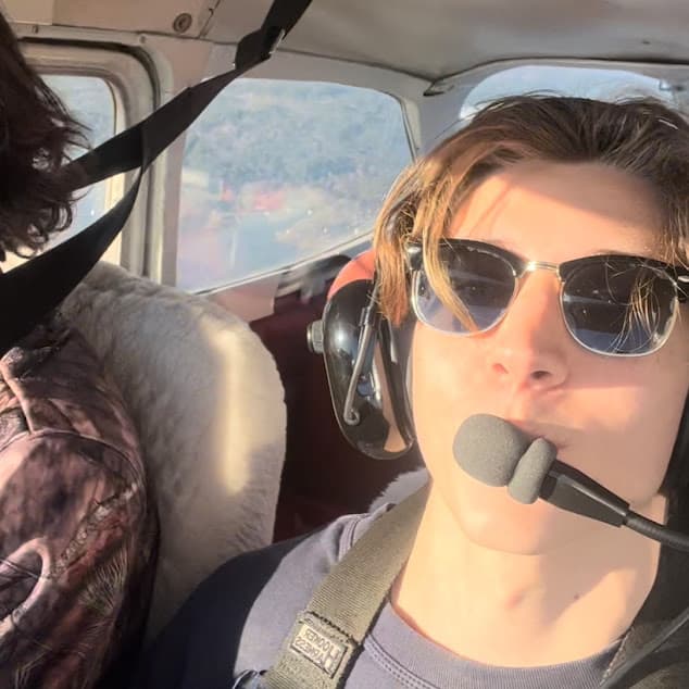 Dylan, founder of Quicklogs, flying with a headset on